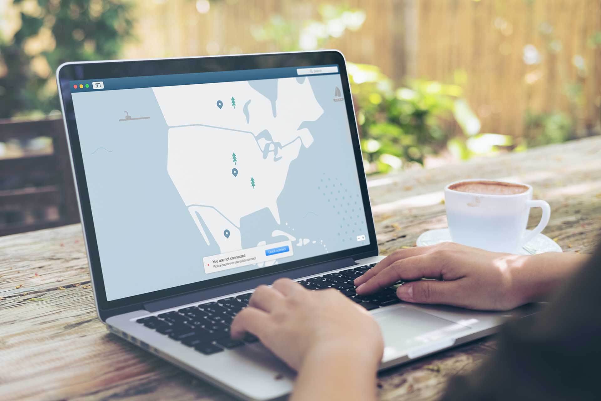 Person at desk connecting to a VPN service to trade cryptocurrencies
