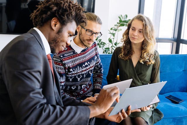 A young couple discussing money myths with their advisor