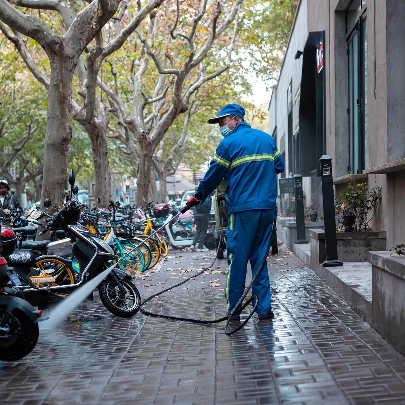 Commercial power washing in a city sidewalk