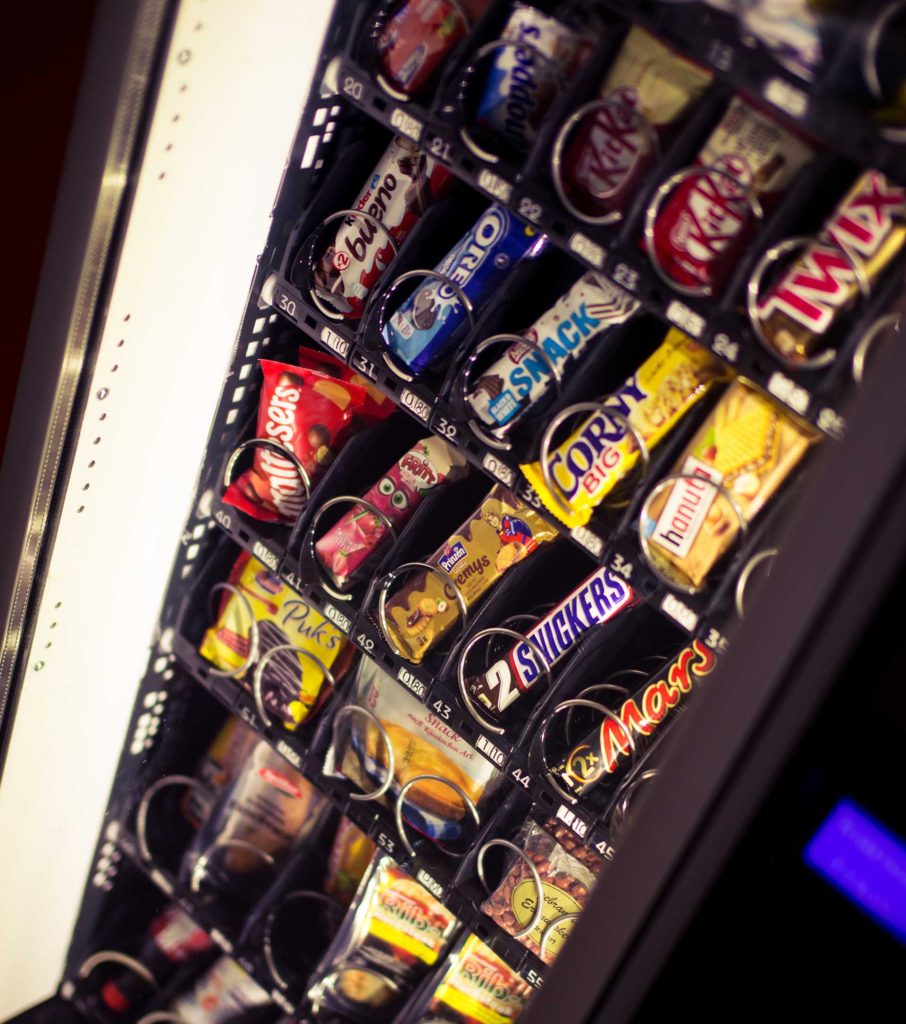 Vending machine stocked with chips and chocolate snacks