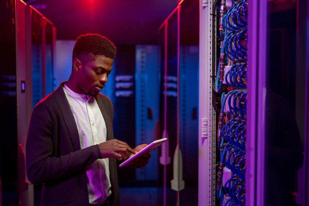 Man operating a large hardware firewall solution for an enterprise sized business