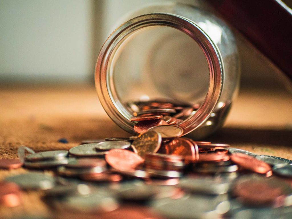 Jar of change pouring out to be counted and rolled