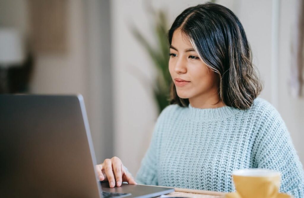 Woman educating herself financially on a laptop