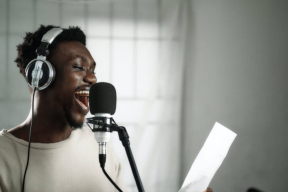 Young man performing a voice over for his Fiverr client