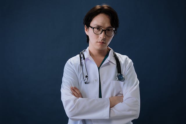 Doctor with arms crossed wearing a stethoscope